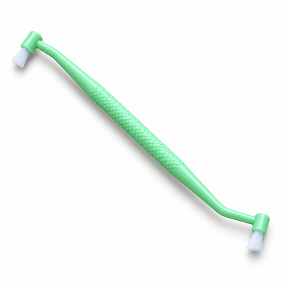 OralIQ Double-Ended Tuft Brush — three-quarter product view on white