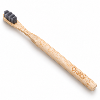 OralIQ bamboo nano toothbrush with its engraved handle facing the camera
