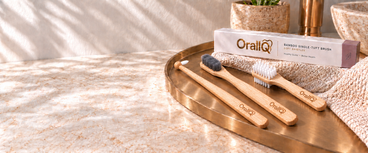 OralIQ bamboo brushes with detailed charcoal bristles, displayed on a gold tray.